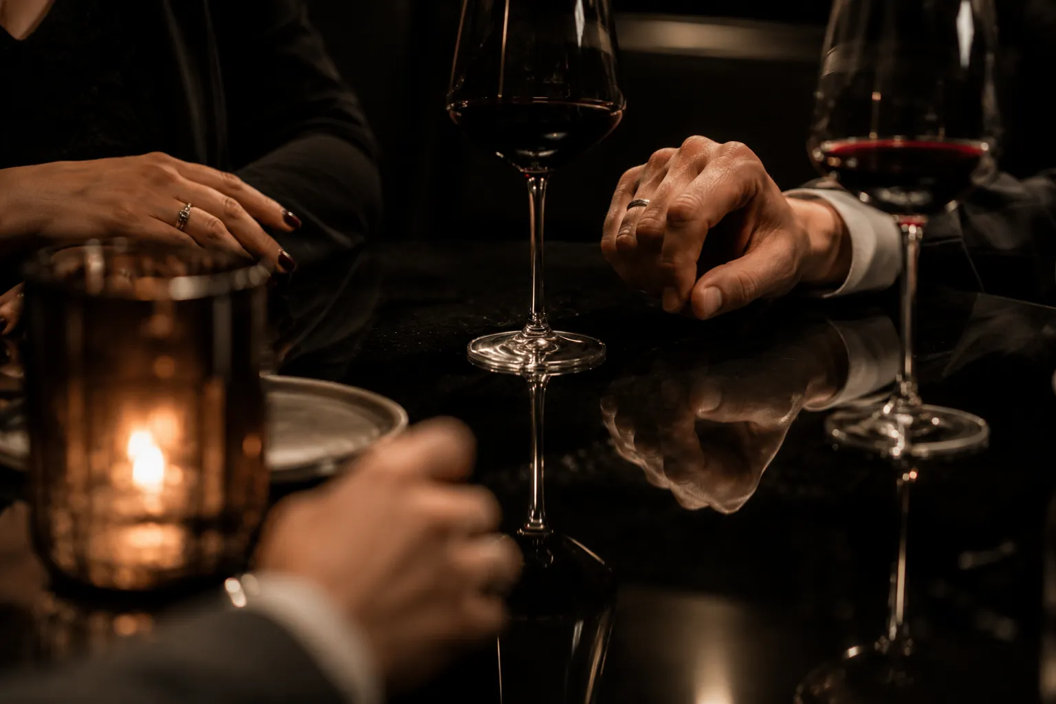Hands toasting with glasses at a social wine-bar table.